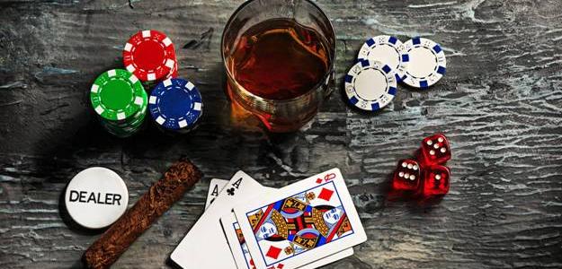 Cards, chips and a glass of drink at table
