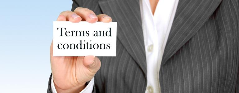 Woman holding a card spelling terms and conditions