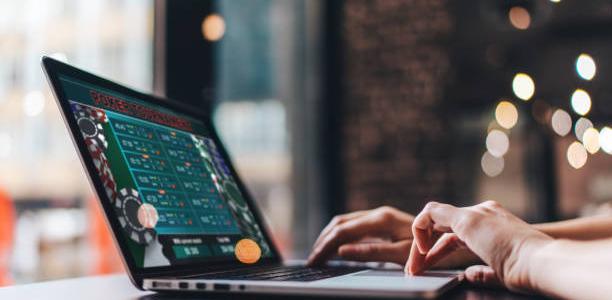 Person playing casino game on laptop