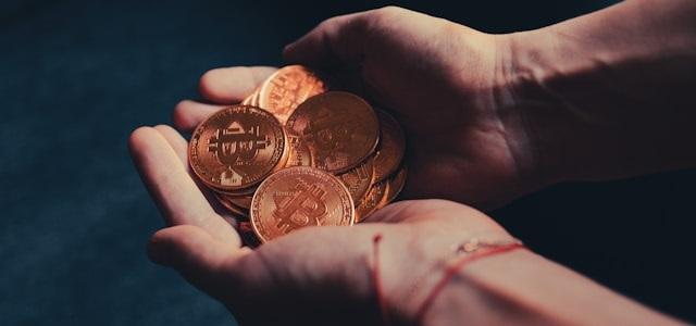 Hands holding stack of bitcoins
