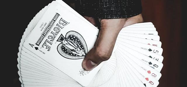 Hand holding card deck spread