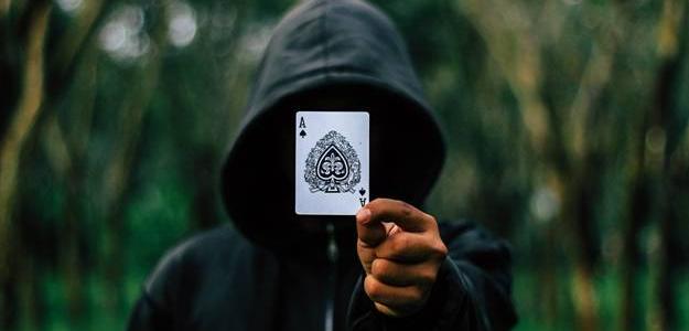 Man in the hoodie holding ace card