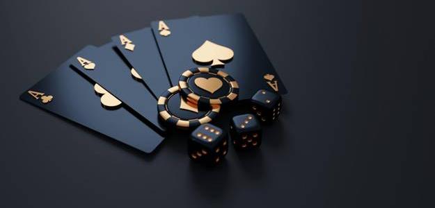A suit of cards, poker chips, and dice lying on a flat surface
