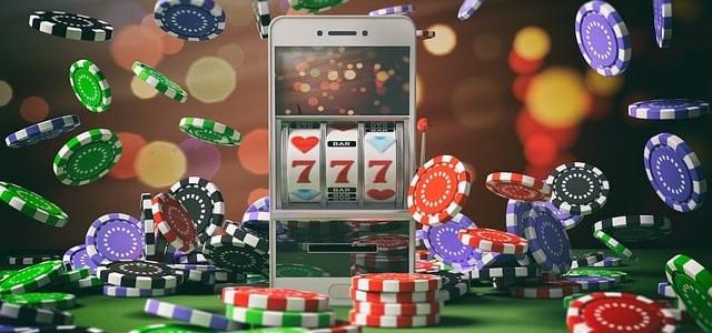Mobile phone with casino slot and casino chips around it Mobile phone with casino slot and casino chips around it