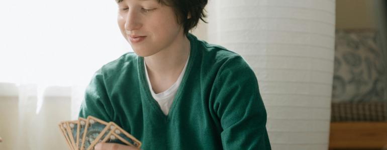 Boy holding playing cards Boy holding playing cards