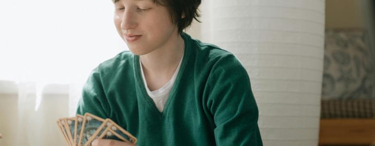 Boy holding playing cards