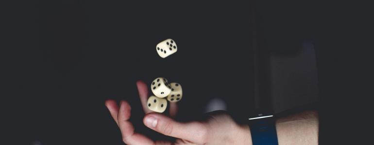 Hand playing with dices